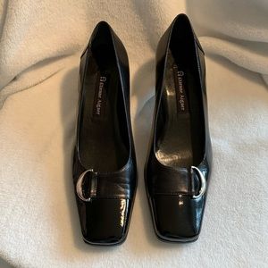 Etienne Aigner black patten leather pumps.